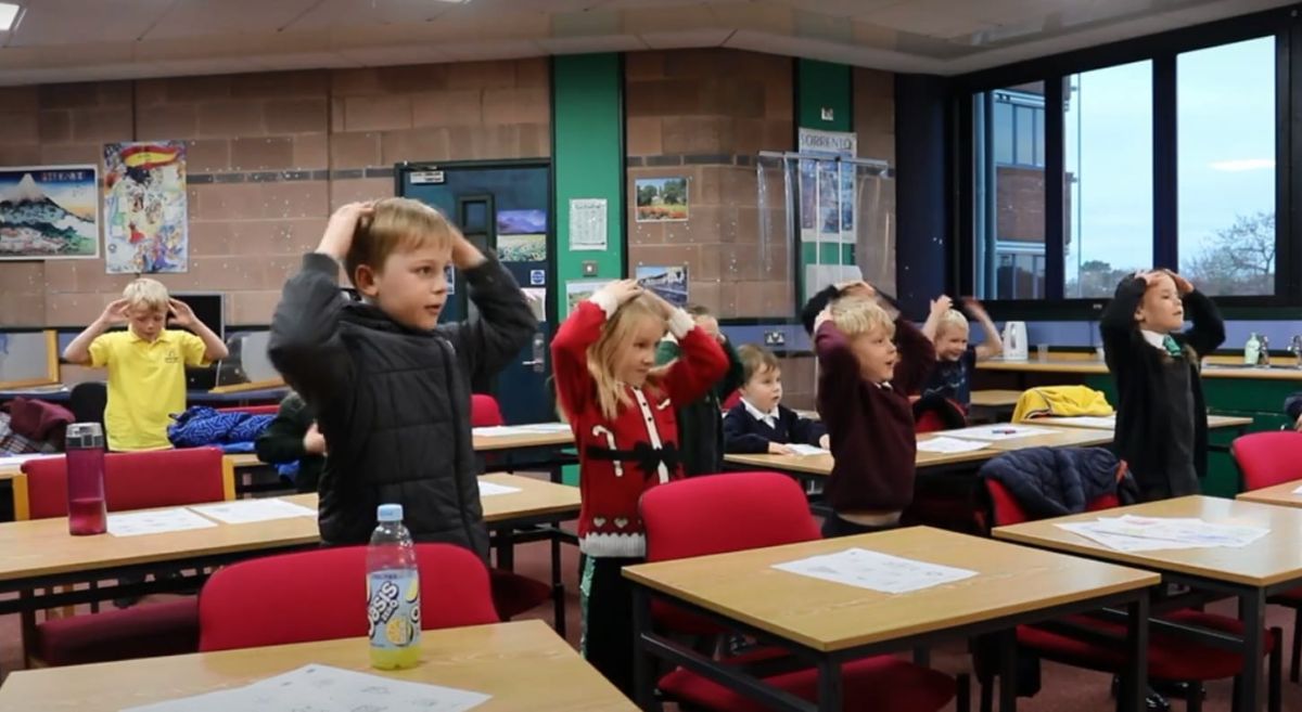 P1 pupils singing along in class